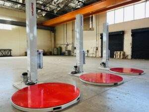 Reference photo showing 3 BestPack CBM pallet wrapper machines.